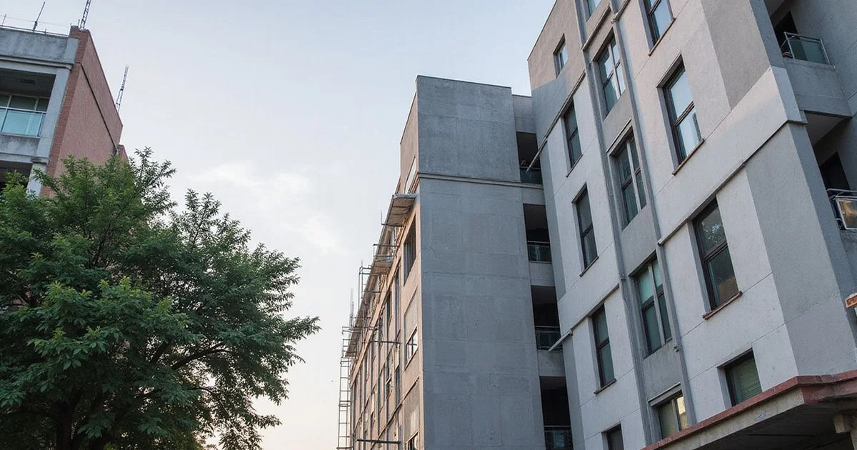 Building with ACP cladding on one wing and plaster finish on another